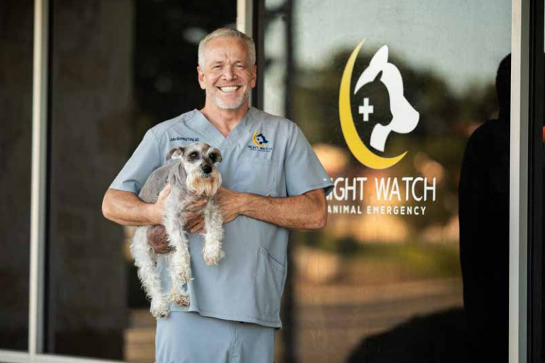 Dr. John Manning of Night Watch Elite Animal Emergency stands with his dog Buff